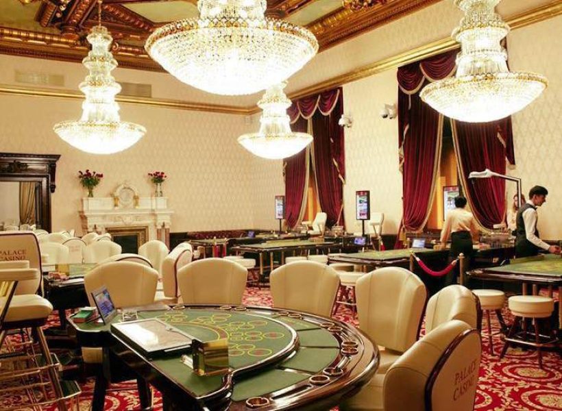 Elegant casino interior with luxurious chandeliers and gaming tables, creating a classy ambiance for entertainment.